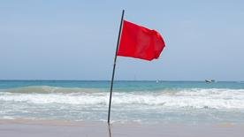 Red beach flag Dangerous conditions: do not enter the water. Signifies a severe hazard, that water conditions are unsafe for swimming and other water activities, and people should not enter the water.