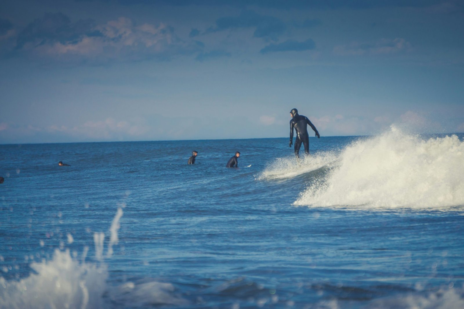 people surfing on sea waves during daytime